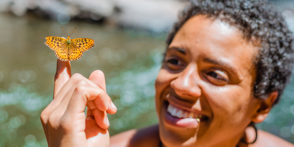 female person of color with butterfly